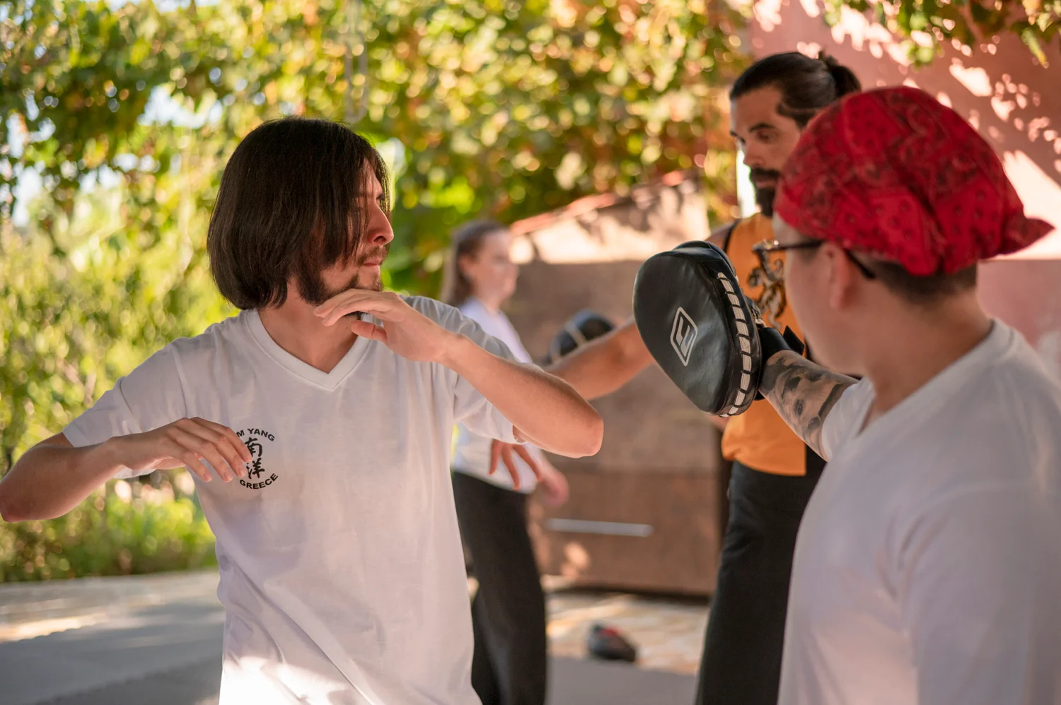 Students practising partner pad work together during training