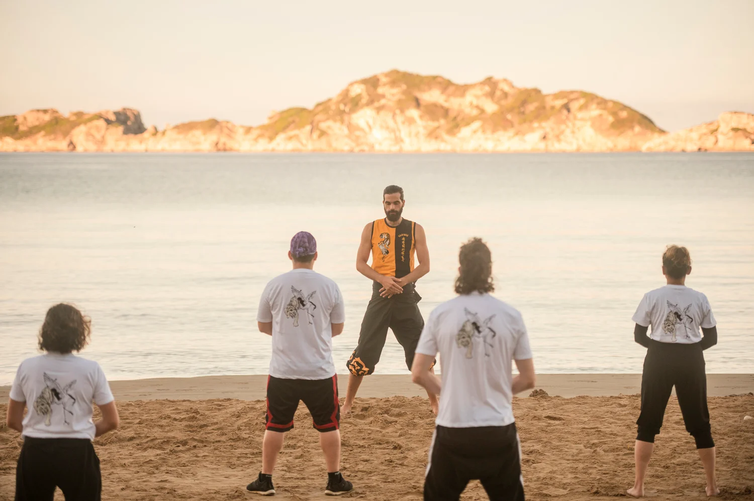 Group training together on the beach during a retreat