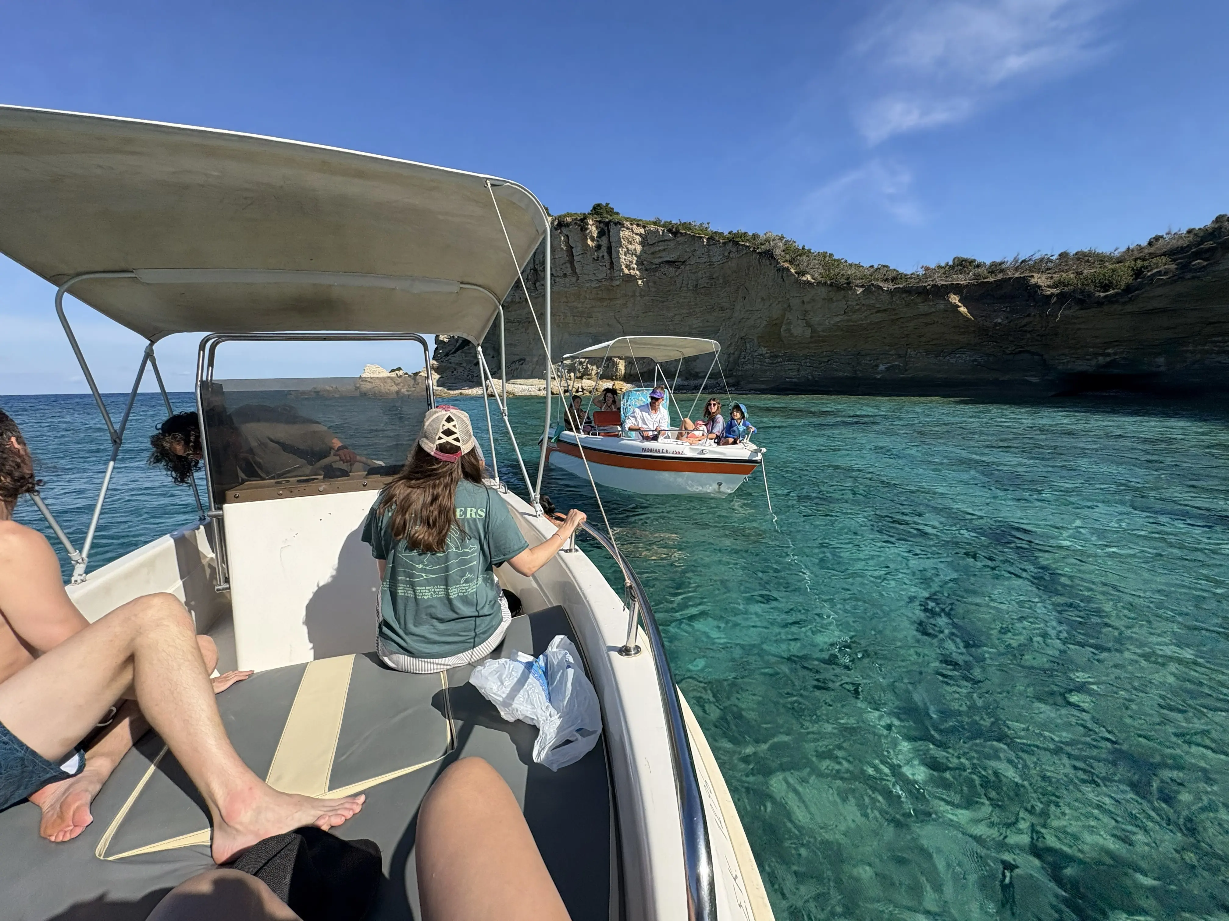 Retreat group exploring the coastline of Corfu by boat