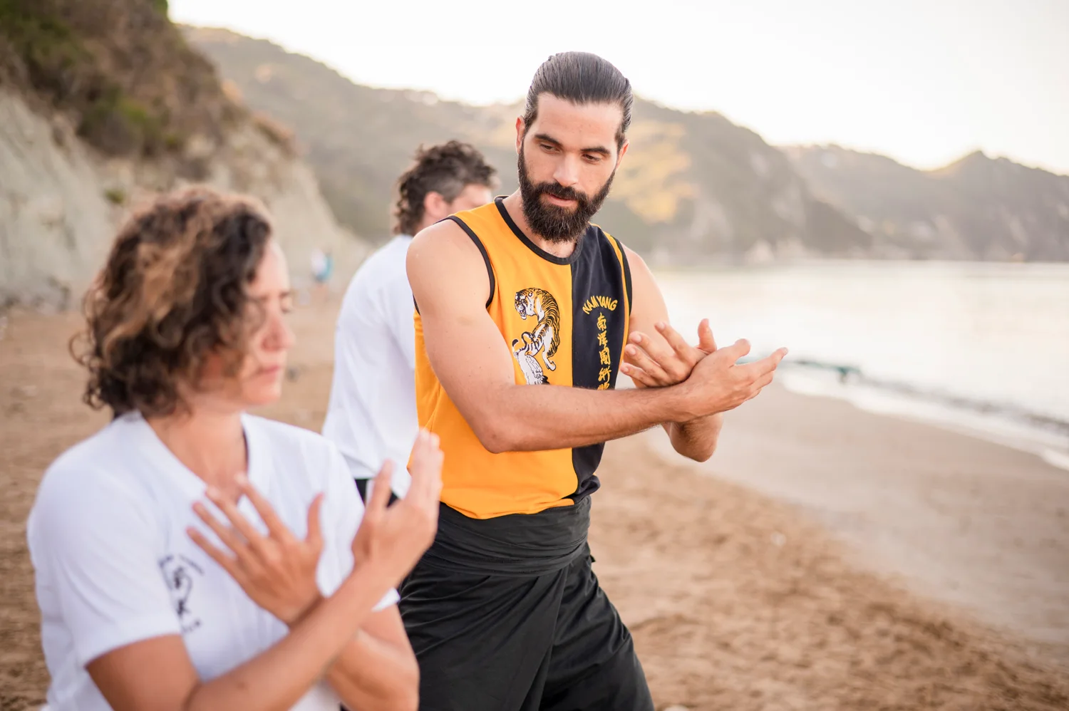 Thomas observing and guiding a student during practice on Arillas beach